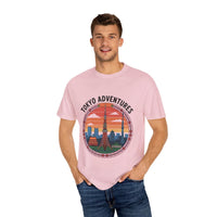 Man wearing pink garment-dyed Tokyo Adventures travel T-shirt with cityscape design