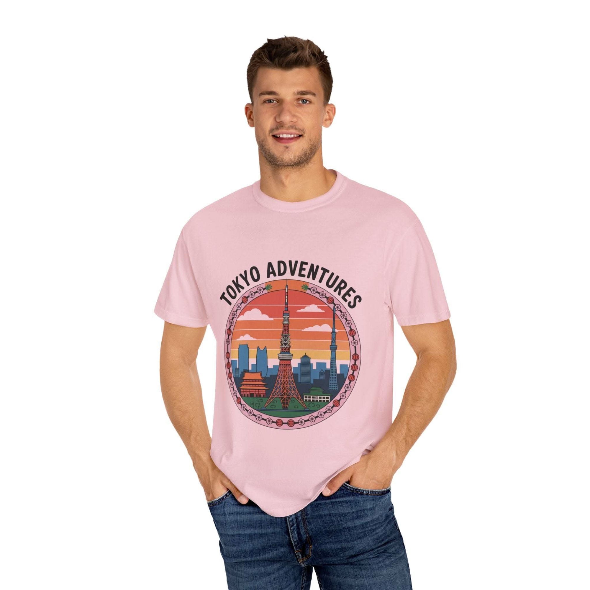 Man wearing pink garment-dyed Tokyo Adventures travel T-shirt with cityscape design