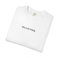 White t-shirt with 'this is me trying' text on a white background