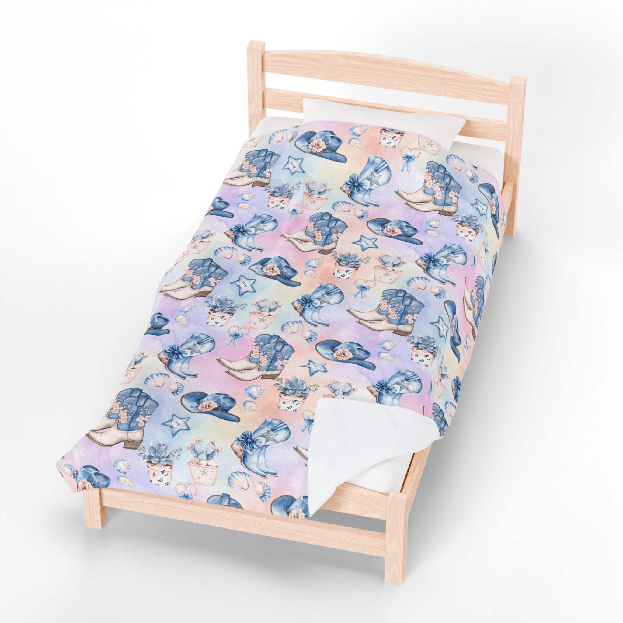 Coastal Cowgirl plush blanket with beach and horse design on bed