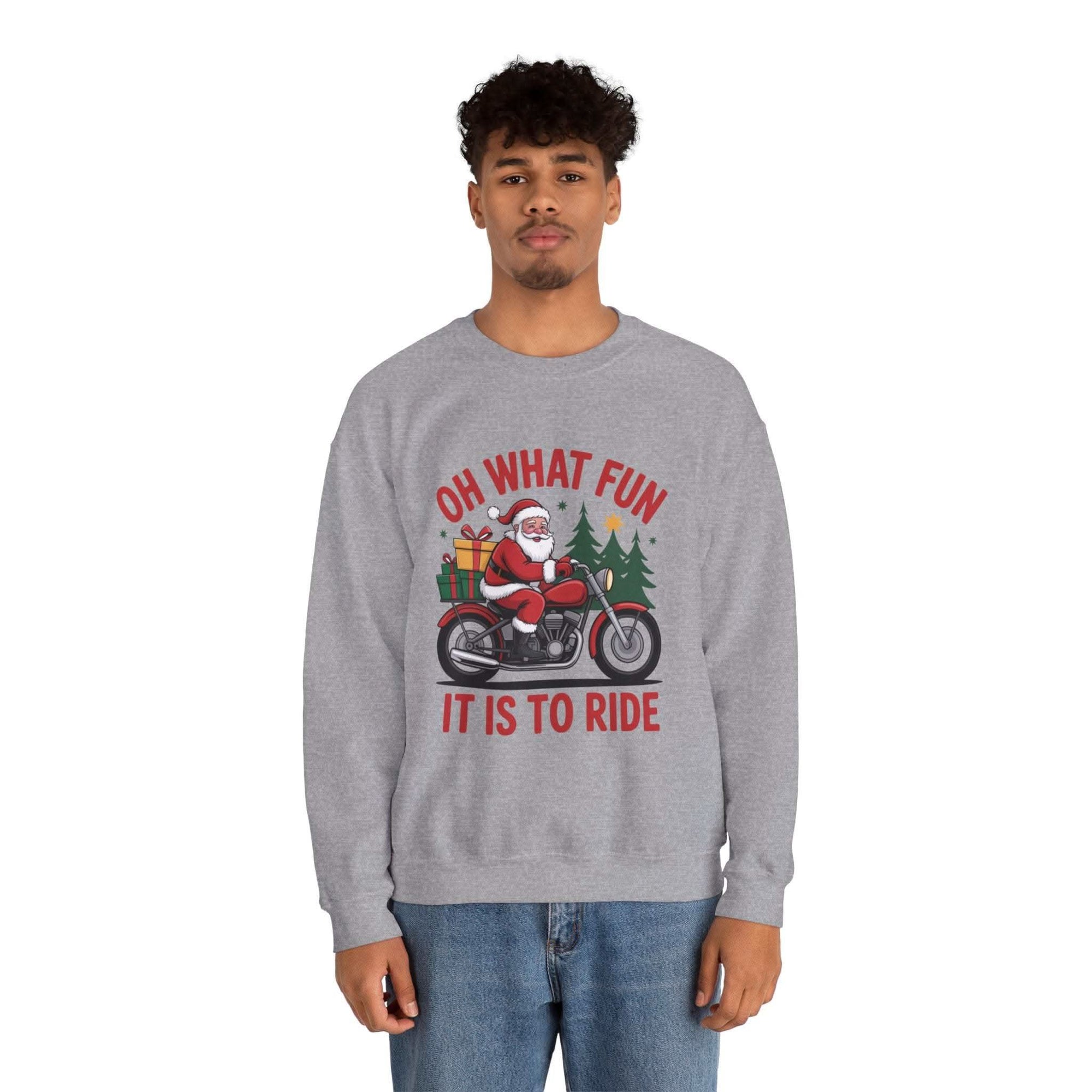 Man wearing navy Motorcycle Santa Sweatshirt with Santa on motorcycle and holiday gifts design in festive setting