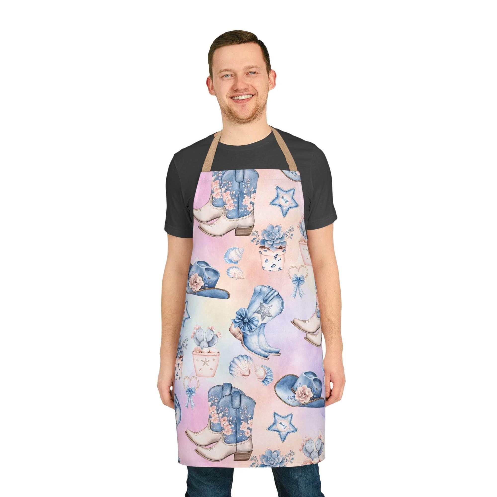 Man wearing pastel coastal cowgirl apron with cowboy boots and hat designs, featuring beige straps.