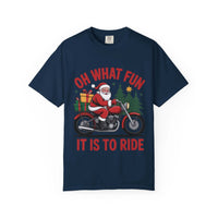Christmas t-shirt featuring Santa on a motorcycle with gifts and festive trees, navy blue background