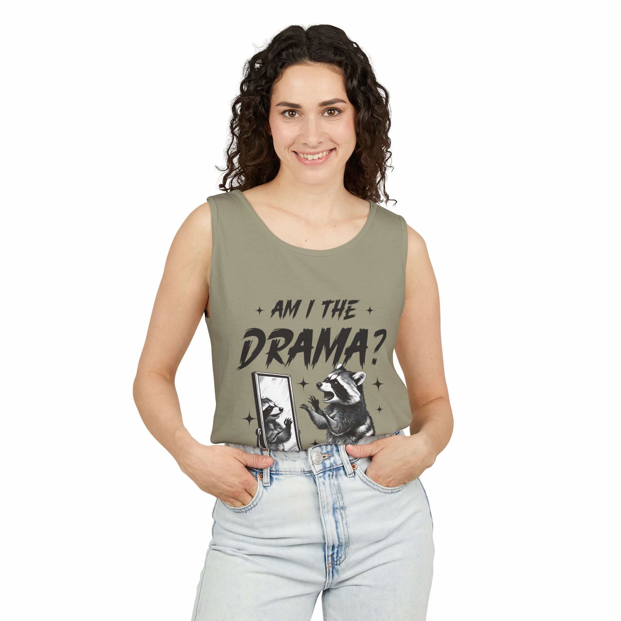 Woman wearing olive green tank top with "Am I The Drama?" text and raccoon graphic, casual summer fashion