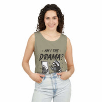 Woman wearing olive green tank top with "Am I The Drama?" text and raccoon graphic, casual summer fashion