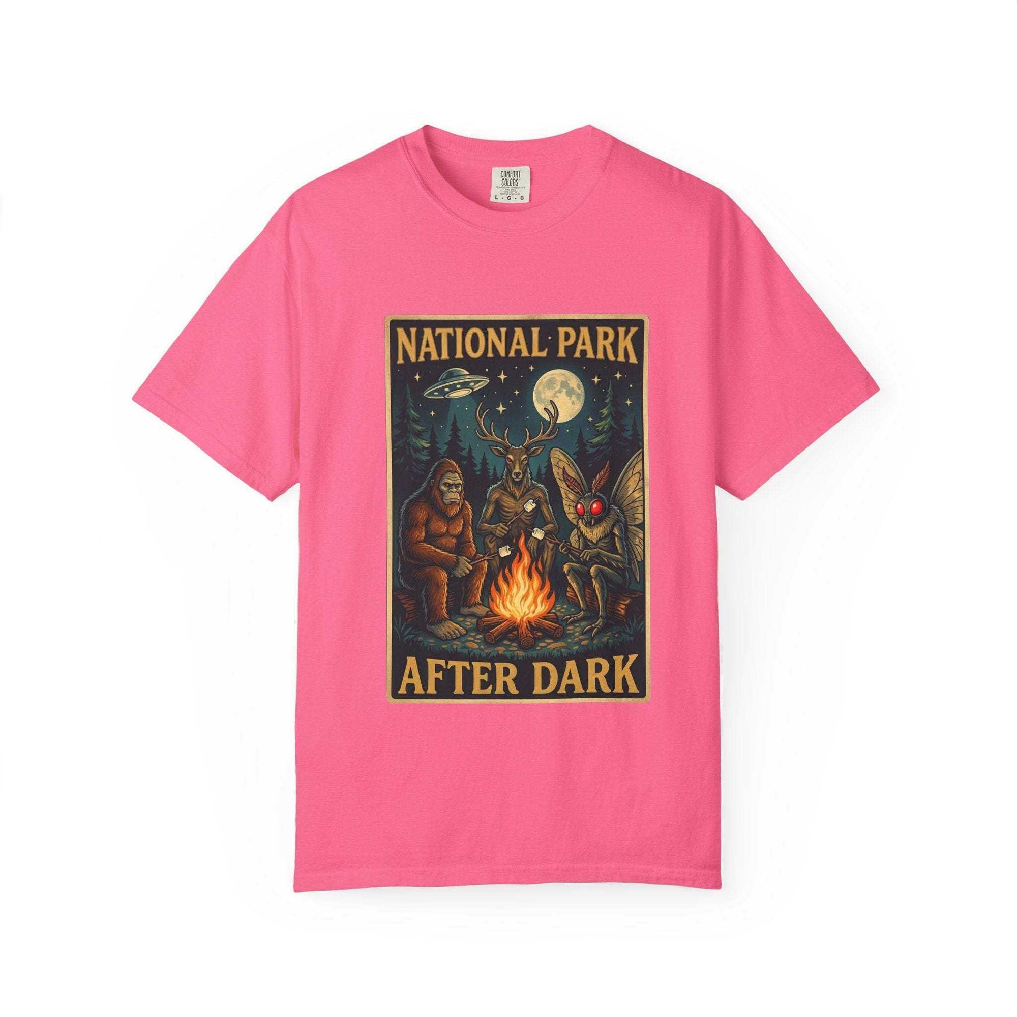 Vintage-style National Park After Dark t-shirt featuring campfire, Sasquatch, Mothman, and nocturnal creatures in a moonlit forest scene