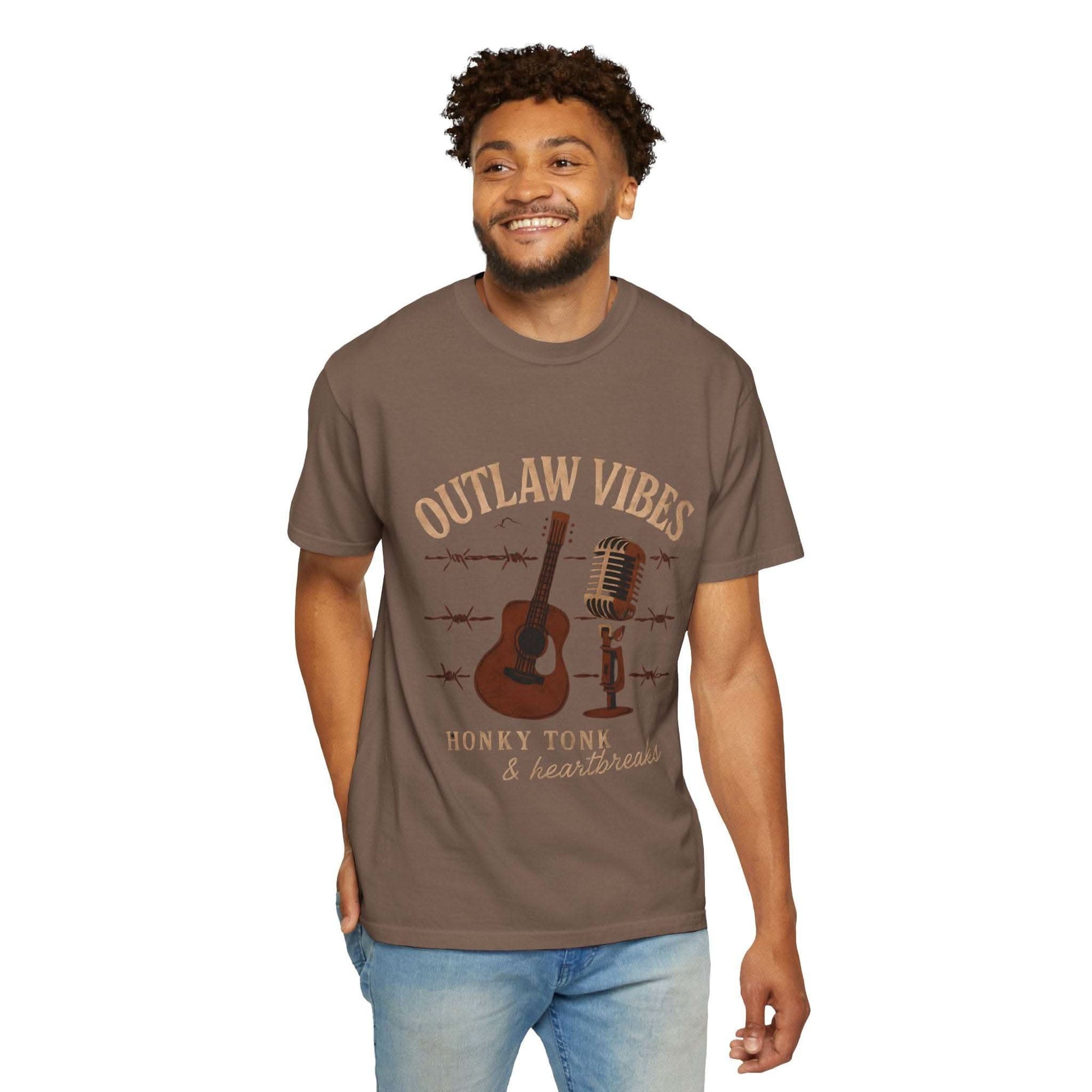 Man wearing a brown t-shirt with 'Outlaw Vibes' graphic design on a white background