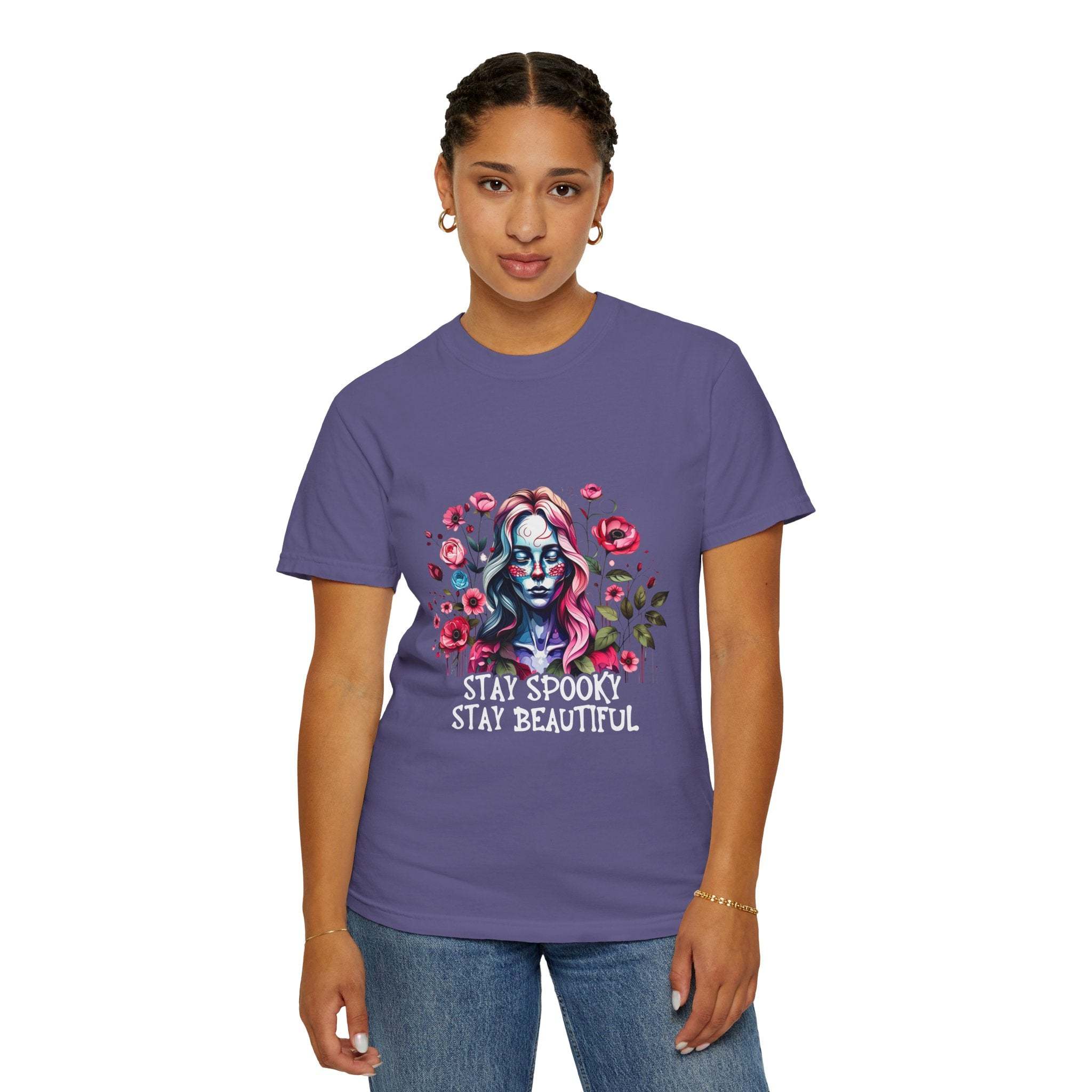 Woman wearing purple floral skeleton t-shirt with "Stay Spooky Stay Beautiful" text and relaxed fit