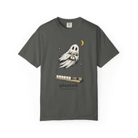 Flat lay of a pepper mahjong T-shirt with a ghost holding a joker tile above a tile rack and “ghosted (he took the joker)” lettering.