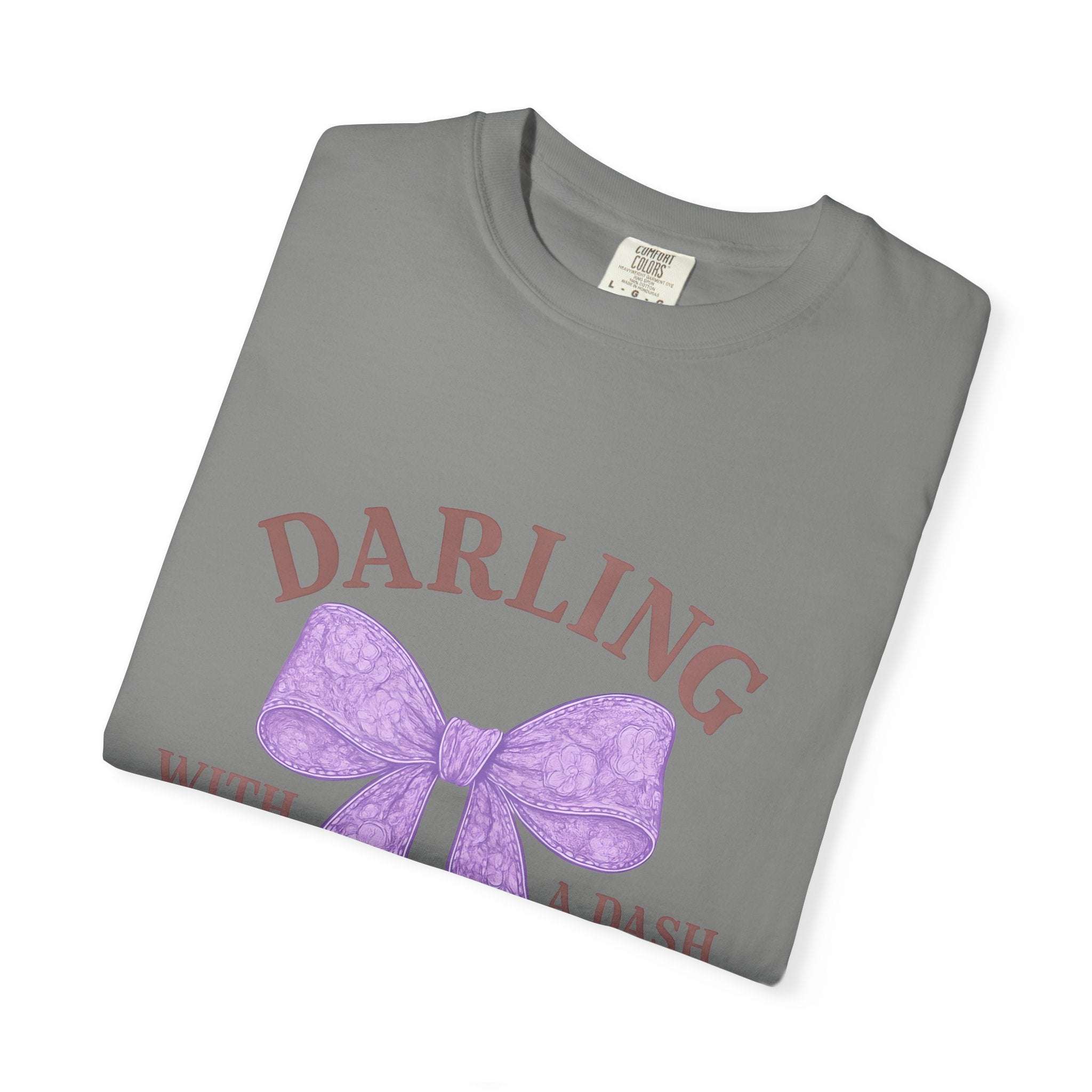 Folded gray t-shirt with a purple bow and text on a white background