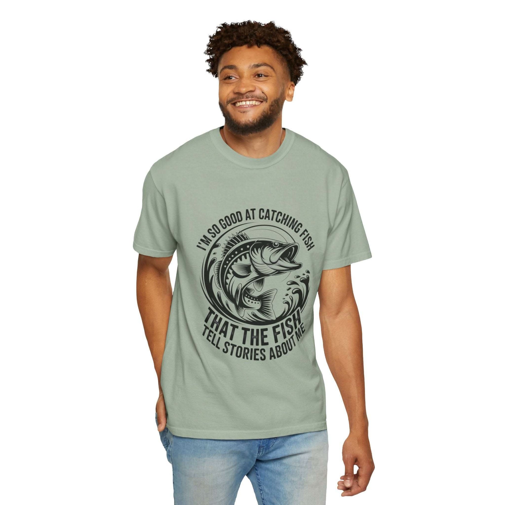 Fishing T-Shirt with humorous "So Good At Catching Fish That The Fish Tell Stories About Me" slogan, soft cotton, relaxed fit.