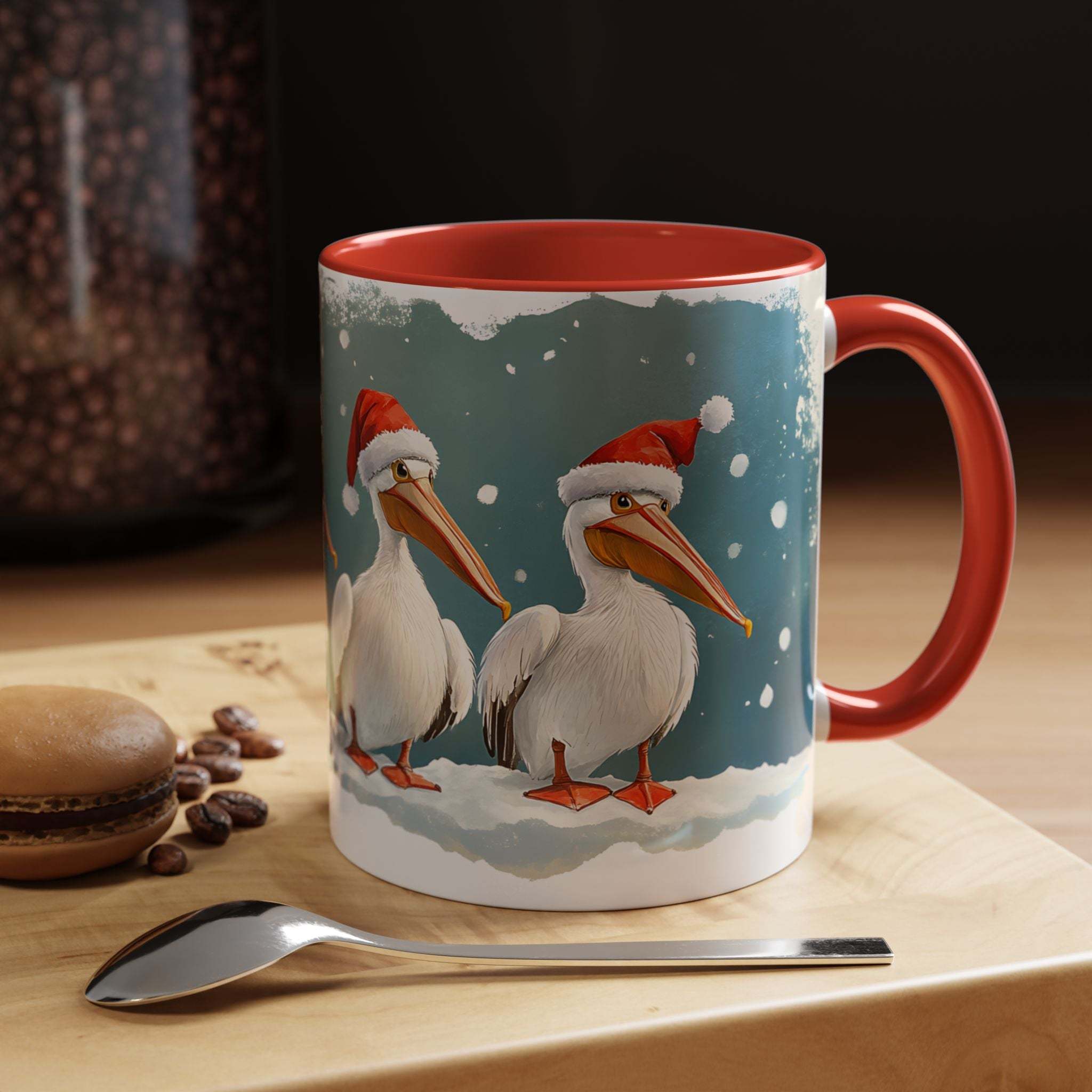 Mug with Christmas-themed design of pelicans wearing Santa hats on a table with coffee beans and a spoon.