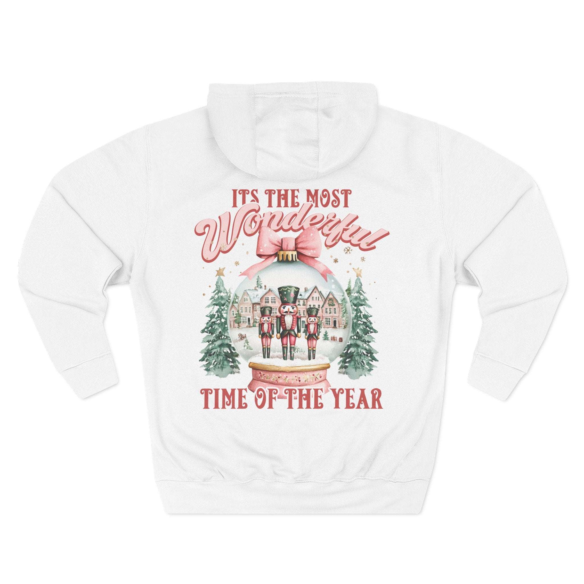 White fleece hoodie with pink snow globe and nutcracker holiday design, cozy winter comfort
