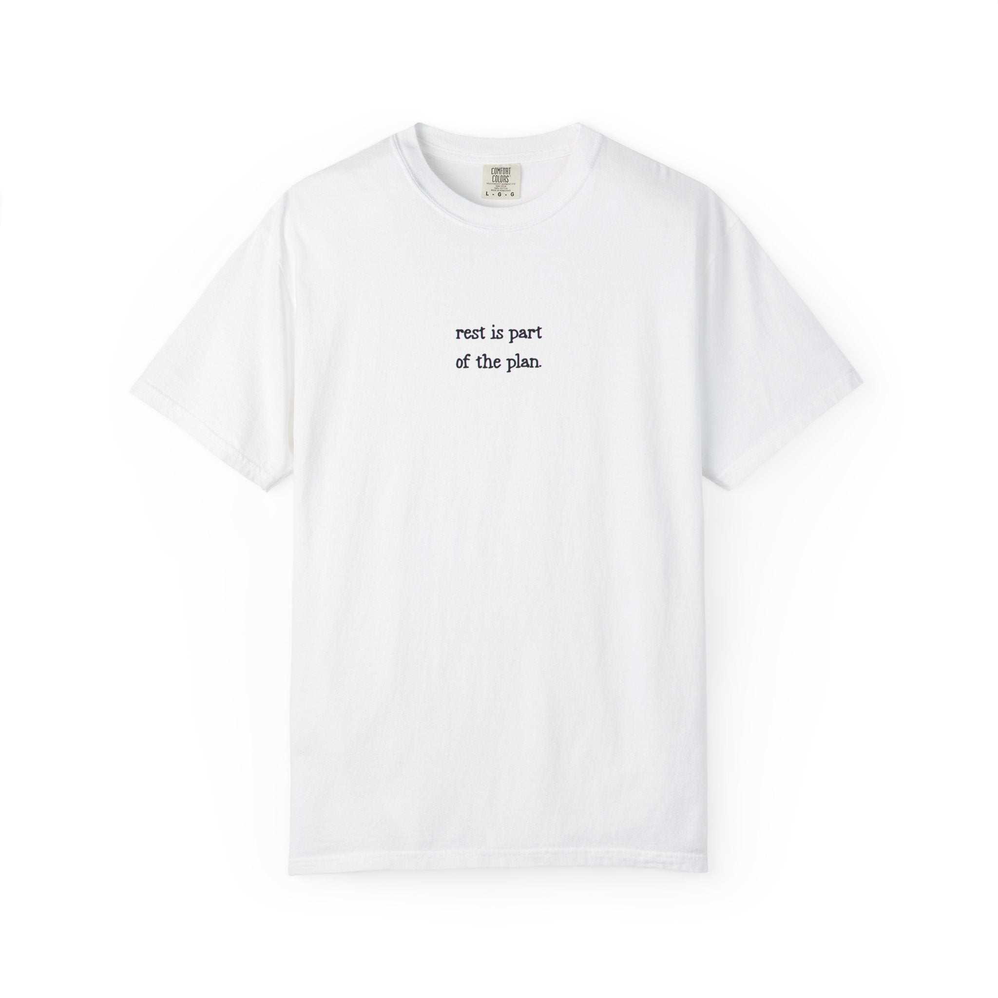 White t-shirt with text 'rest is part of the plan' on a white background