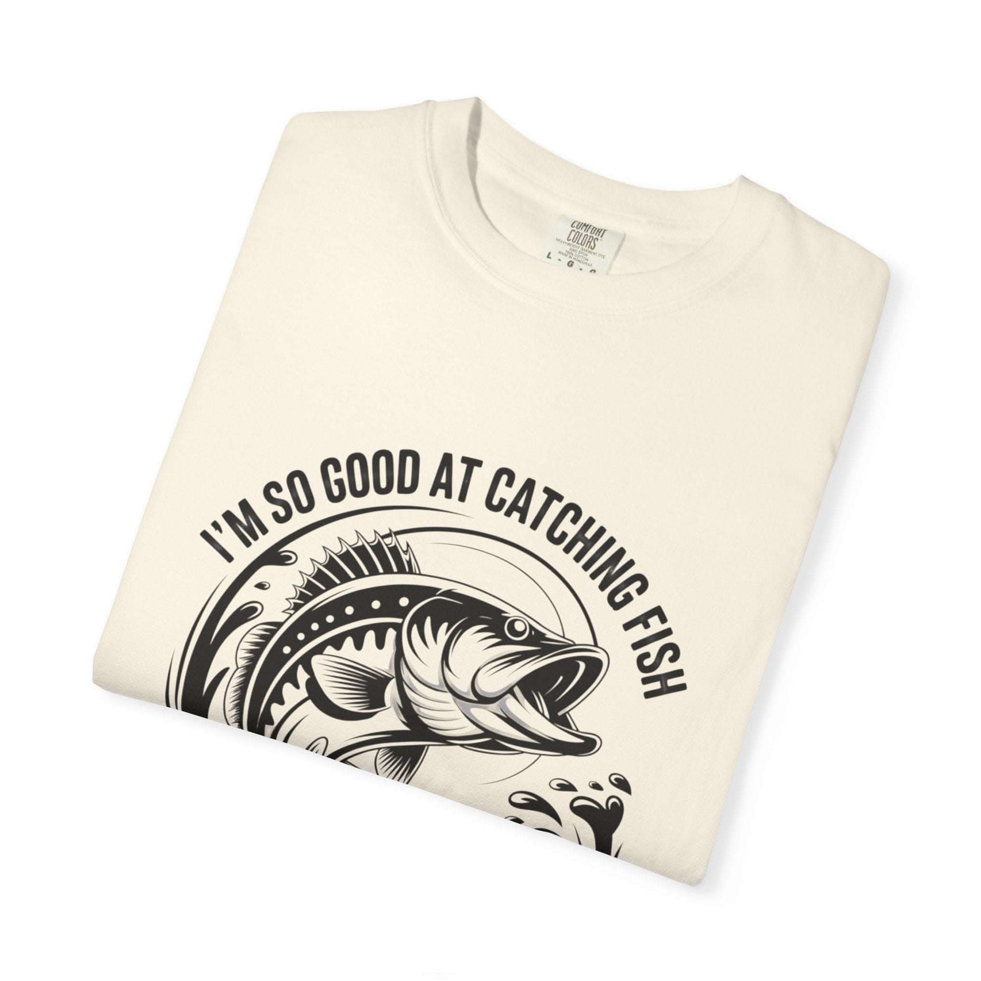 Fishing T-Shirt with humorous "So Good At Catching Fish That The Fish Tell Stories About Me" slogan on soft cotton tee