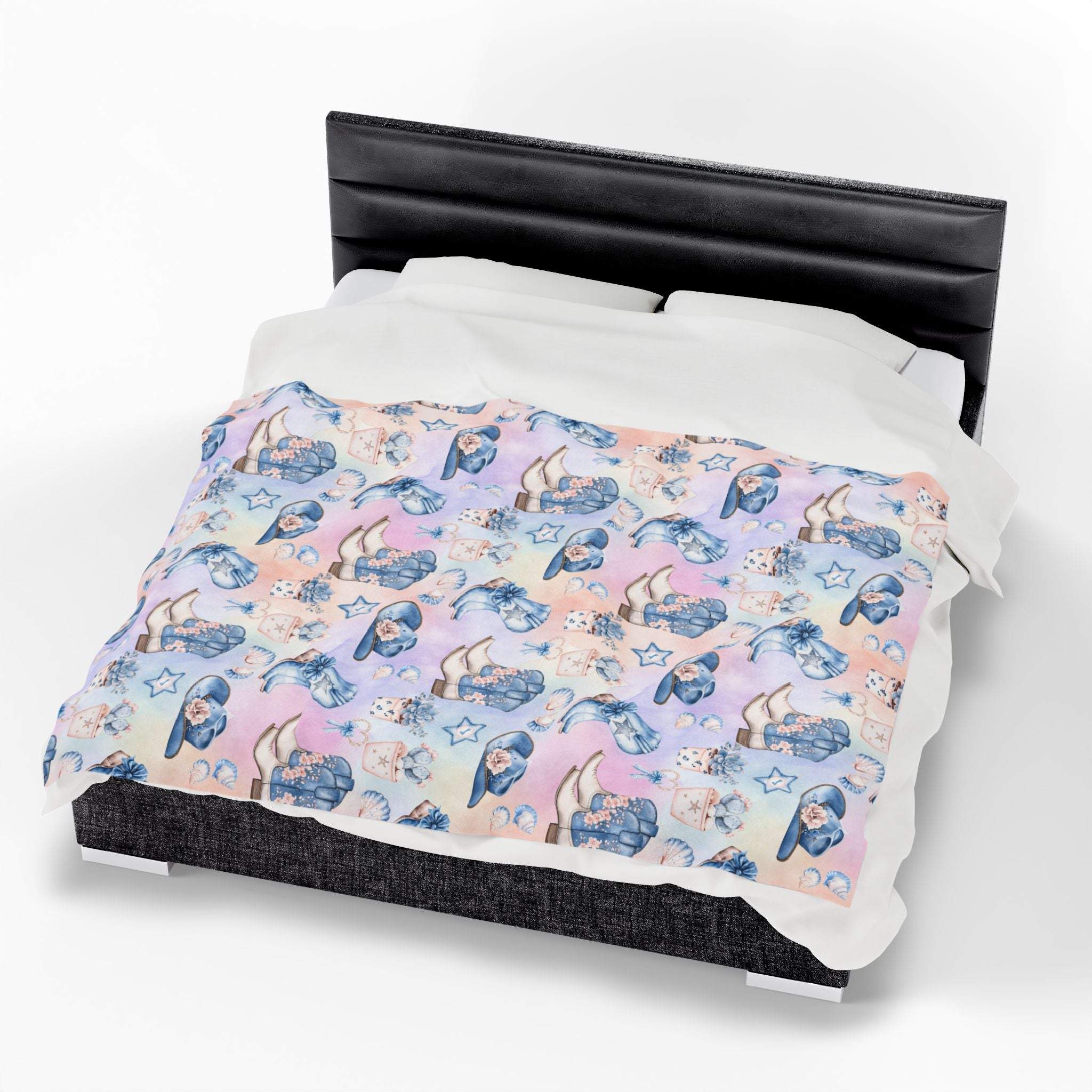 Coastal Cowgirl design plush blanket with pastel beach and horse pattern on bed