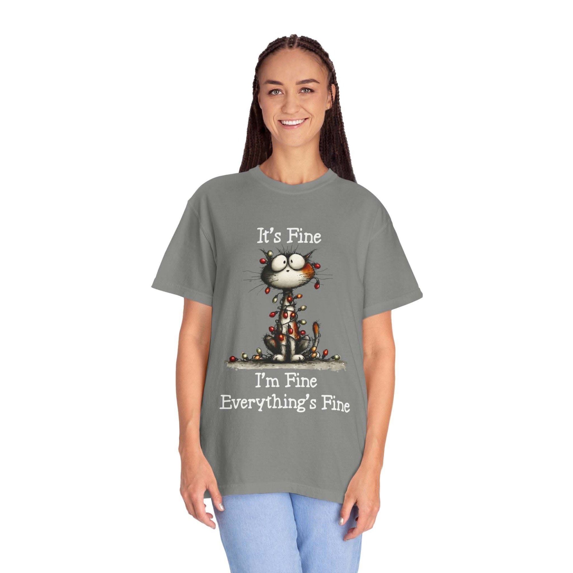 Person wearing a gray t-shirt with a cat graphic and text on a white background