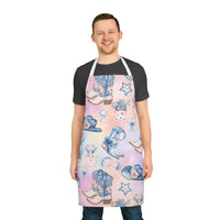 Man wearing pastel coastal cowgirl apron with cowboy boots and floral designs