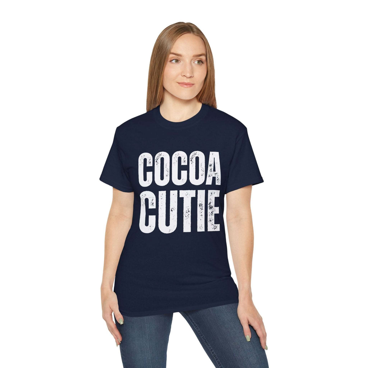 Woman wearing navy distressed Cocoa Cutie Tee with bold white text on front