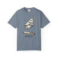 Flat lay of a blue jean mahjong T-shirt with a ghost holding a joker tile above a tile rack and “ghosted (he took the joker)” lettering.