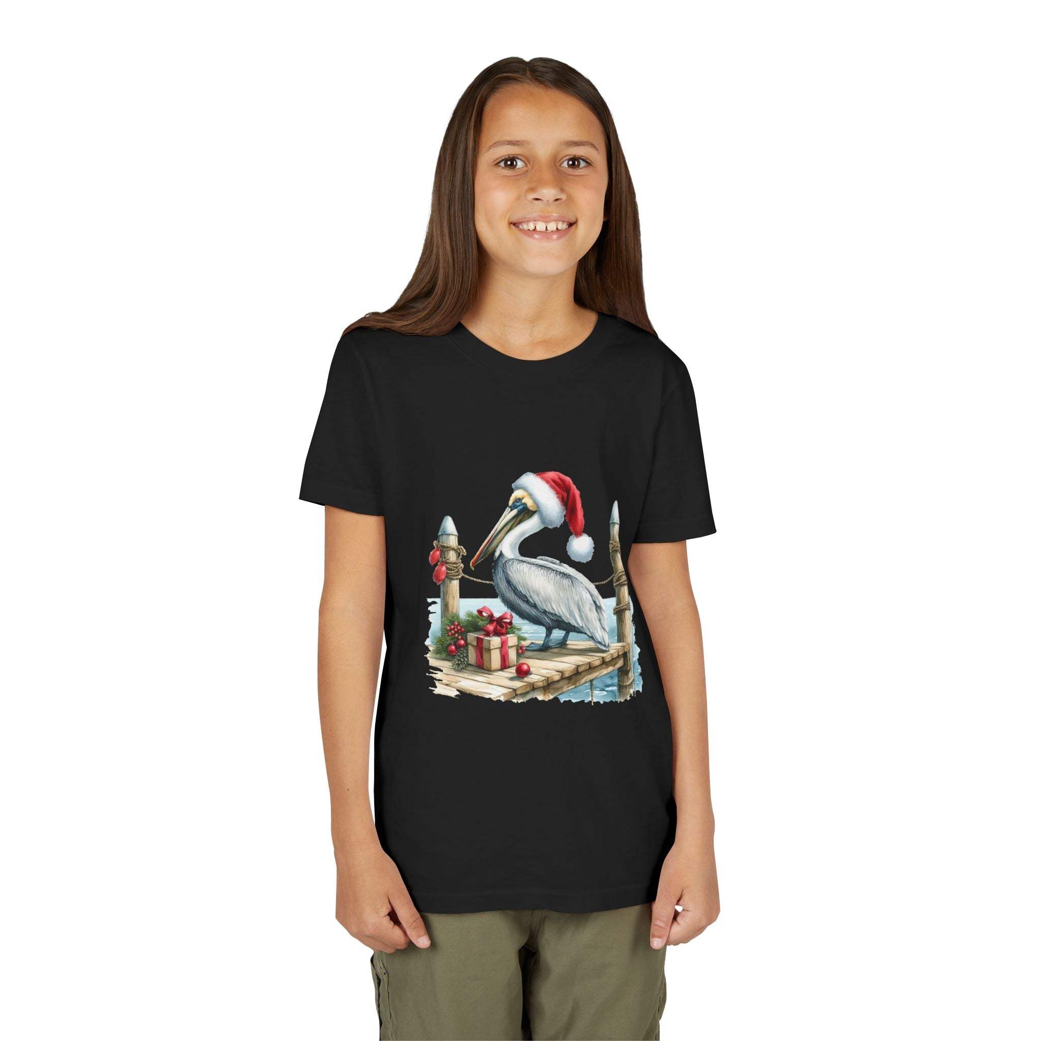 Child wearing a black t-shirt with a Christmas pelican design on a white background