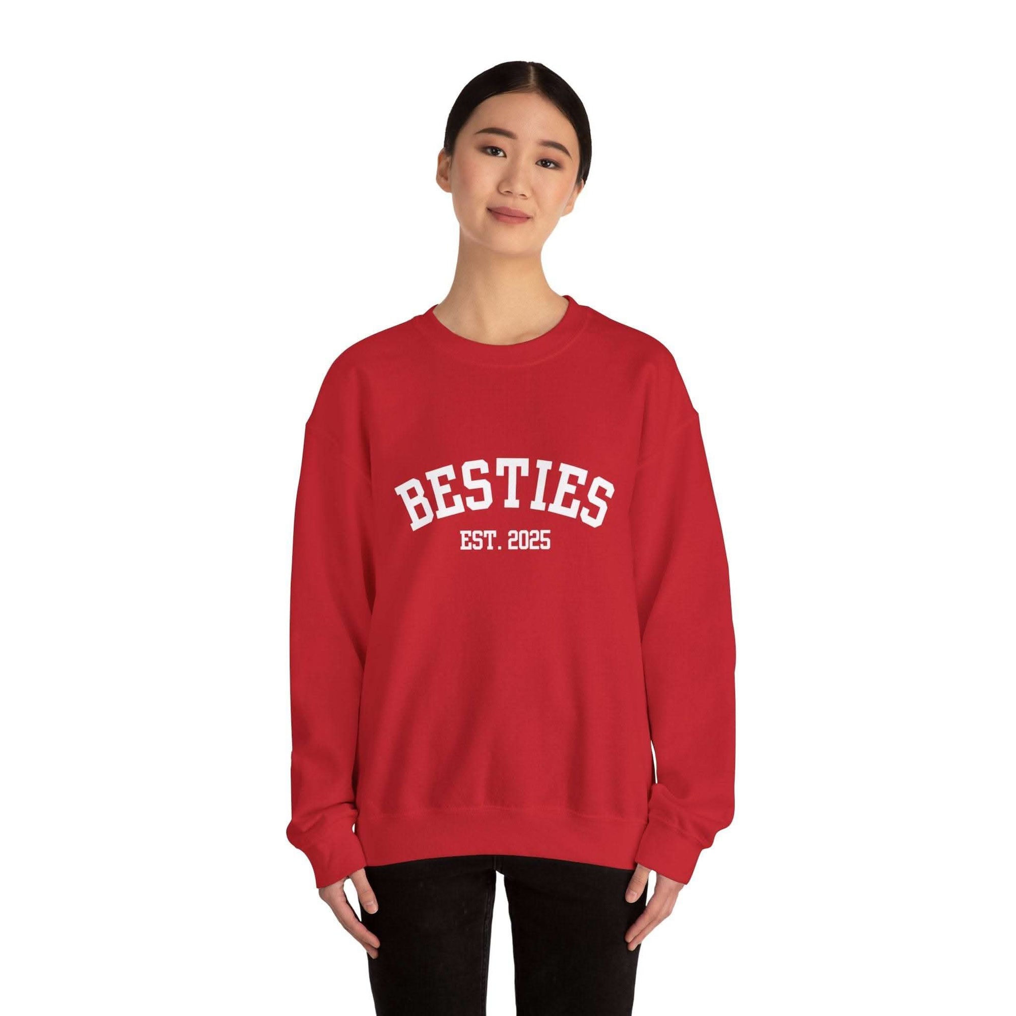 woman wearing red Varsity Besties Crewneck Sweatshirt with white Besties EST. 2025 lettering