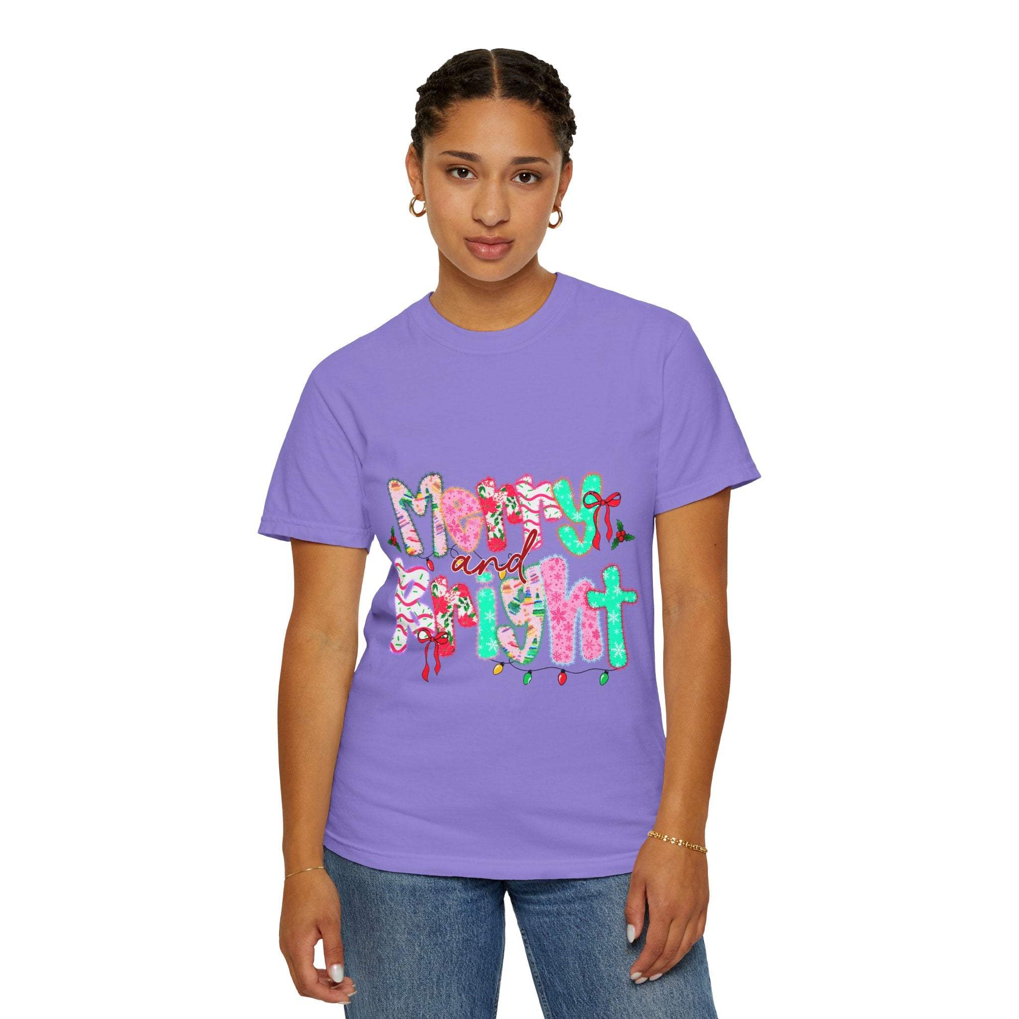 Woman wearing purple Merry and Bright T-shirt with holiday-themed lettering and festive design