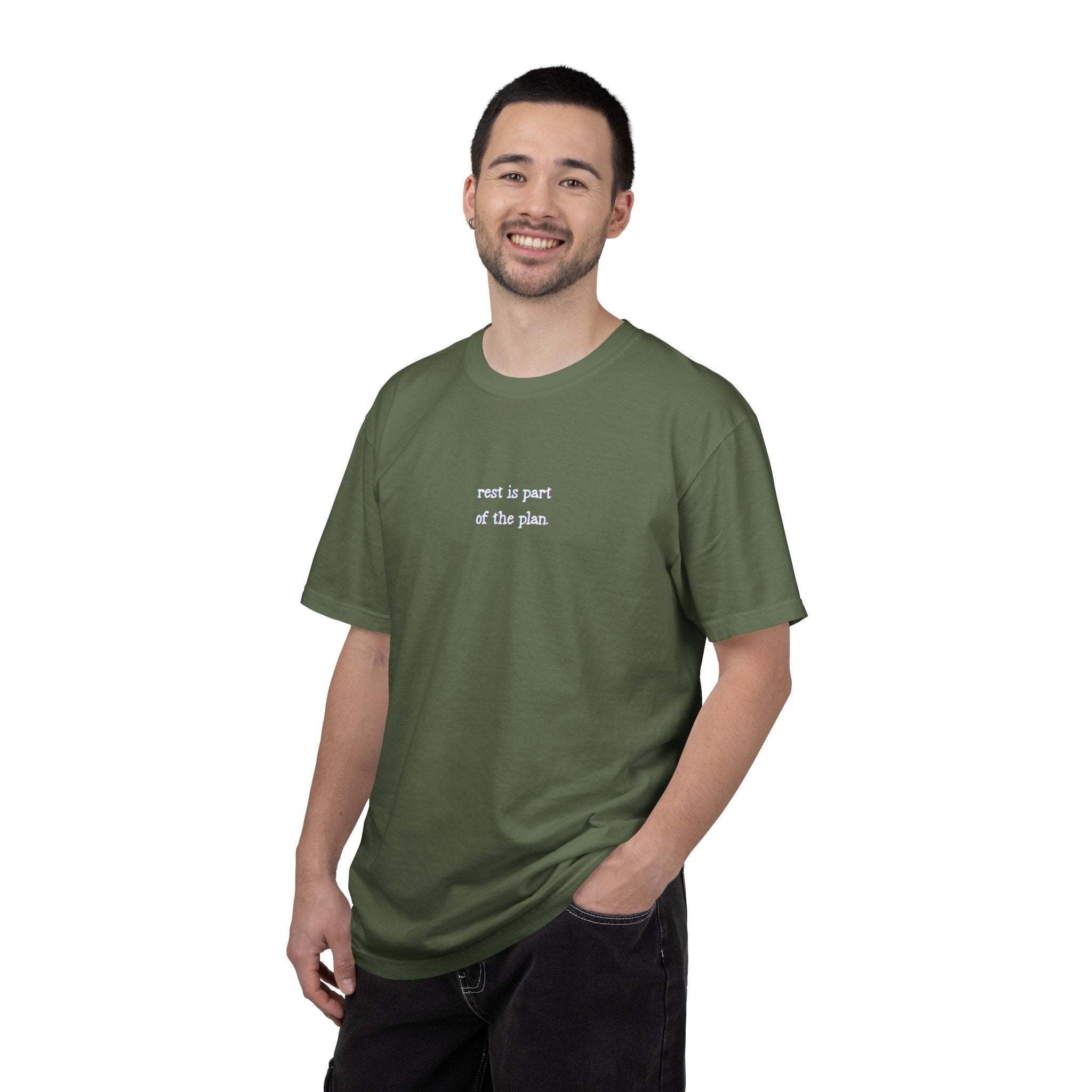 Man wearing a green t-shirt with text on a white background