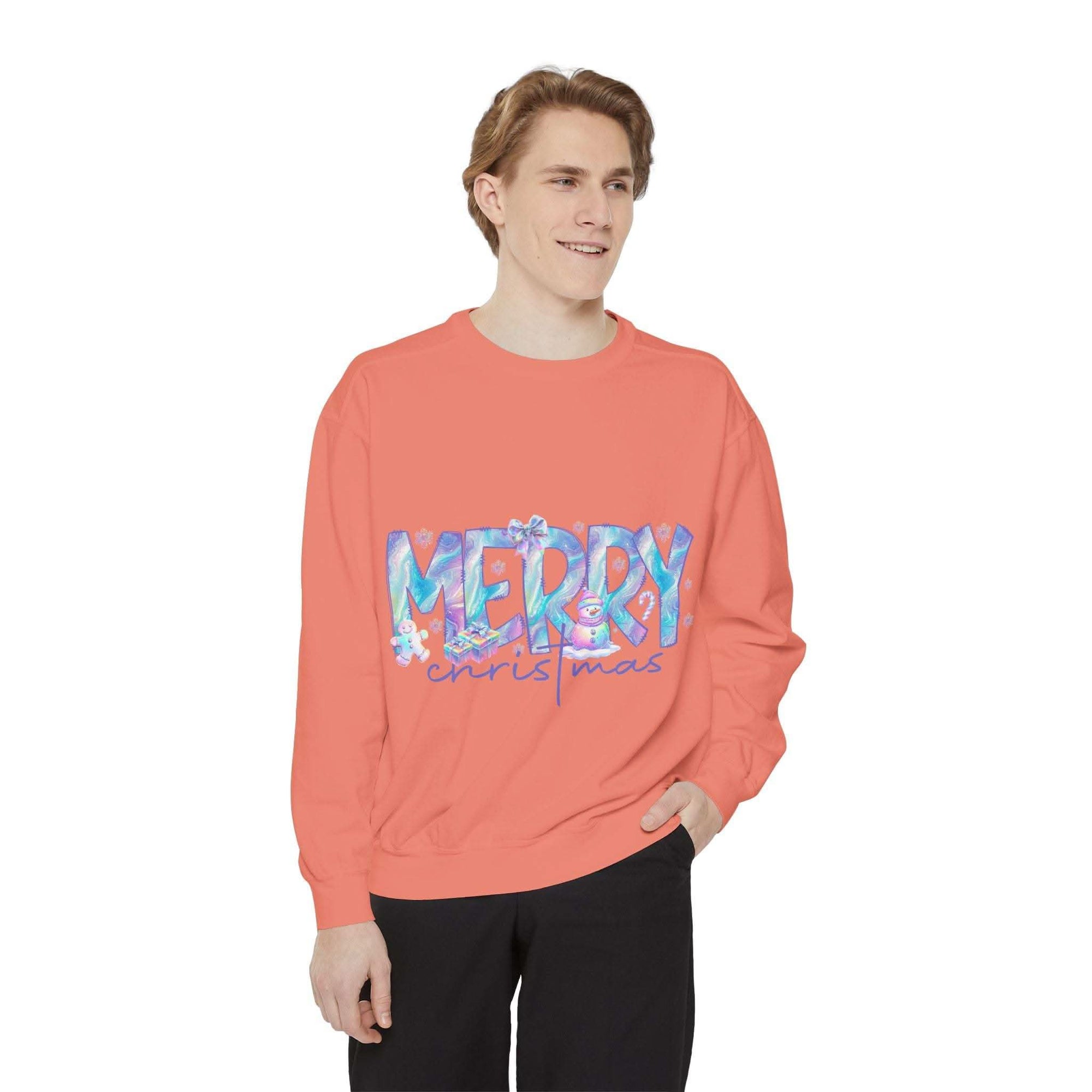 young man wearing coral iridescent Merry Christmas sweatshirt with relaxed fit and ribbed cuffs