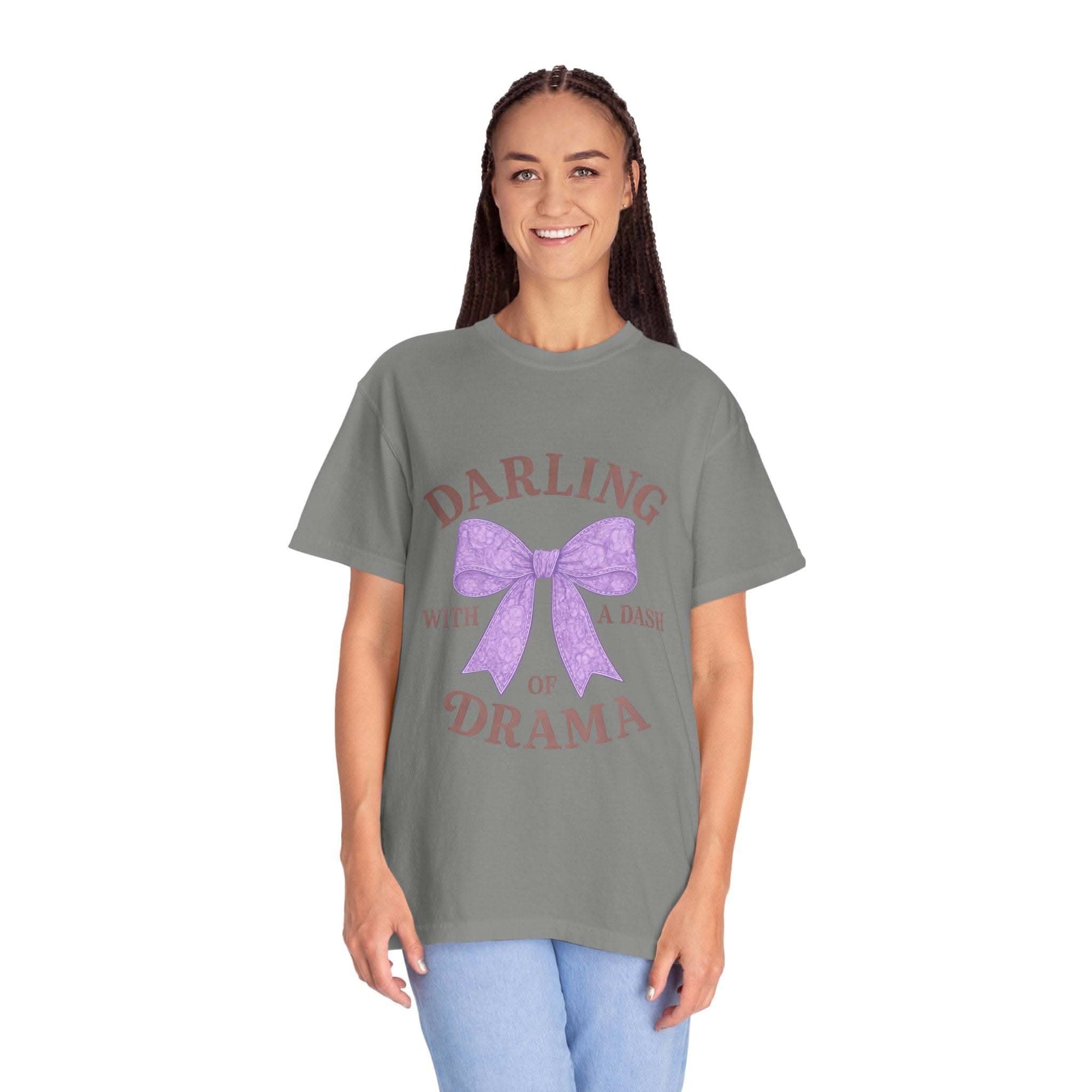 Woman wearing a gray t-shirt with a purple bow and text design on a white background
