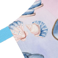 Pastel Coastal Cowgirl apron with seashell design and blue strap