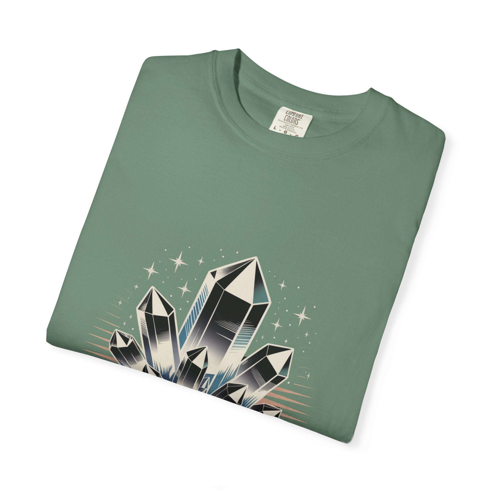 Folded green t-shirt with crystal graphic on a white background