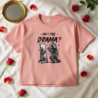 Pink women's boxy tee with "Am I The Drama?" text and raccoon graphic, vintage style cotton shirt