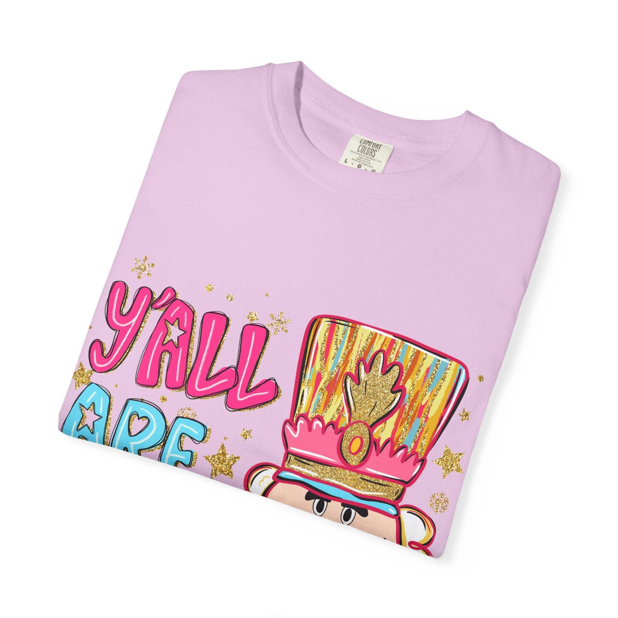 Folded lavender Yall Are Nuts Nutcracker T-shirt with colorful festive nutcracker design and playful text