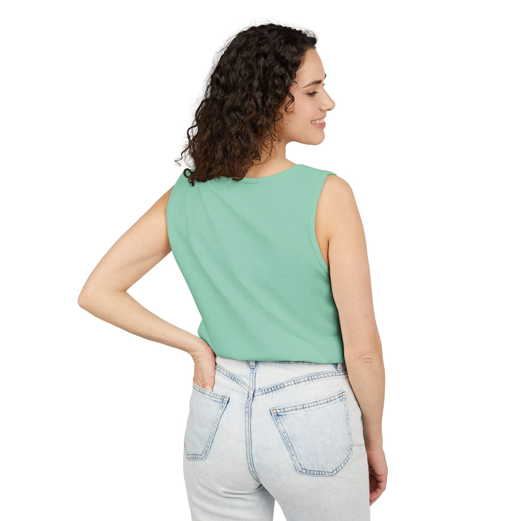 Woman wearing a green sleeveless tank top with light wash jeans back view