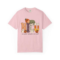 Blossom pink NICU nurse Halloween T-shirt with patchwork lettering, a sleeping baby in a pumpkin hat, ghosts, and jack-o’-lanterns.