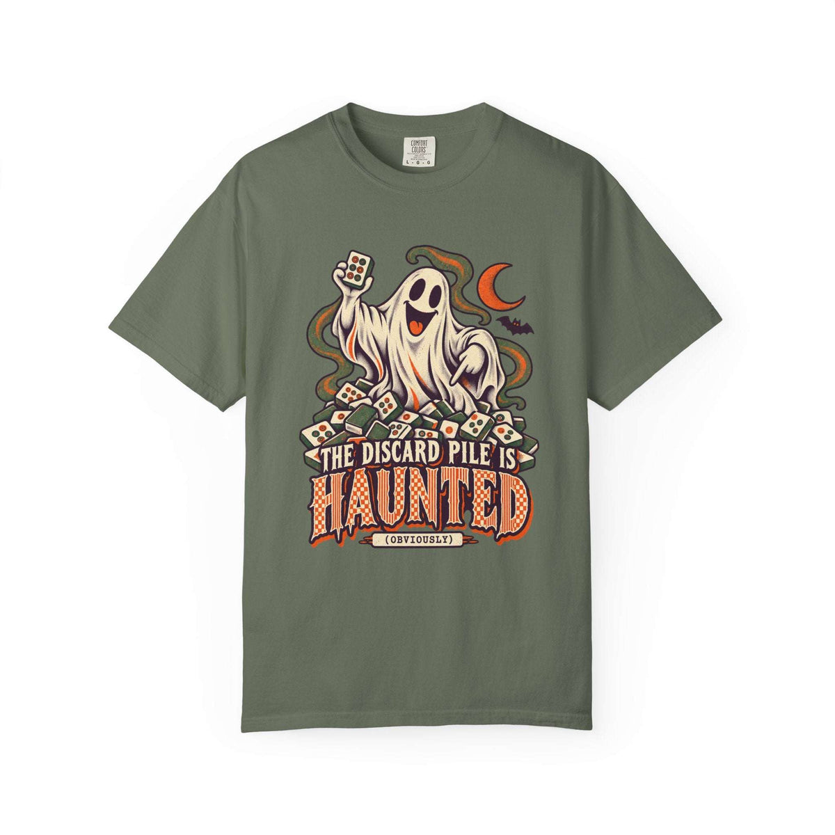 Moss green Comfort Colors 1717 Halloween mahjong T-shirt with a ghost holding a tile and “The Discard Pile Is Haunted (Obviously)” lettering.