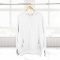 White fleece hoodie with adjustable hood and kangaroo pocket hanging on wooden hanger