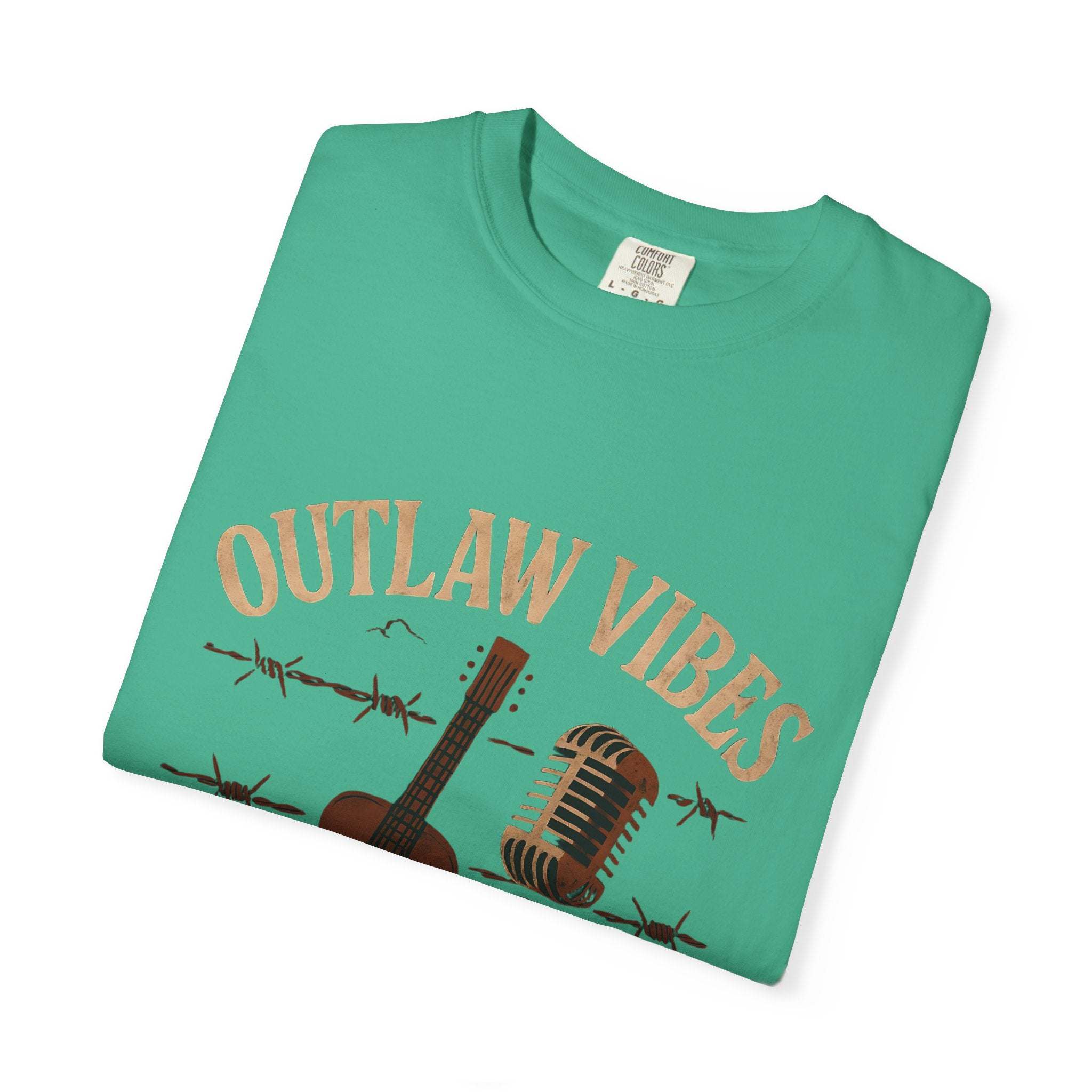 Green t-shirt with 'Outlaw Vibes' text and guitar graphic on a white background