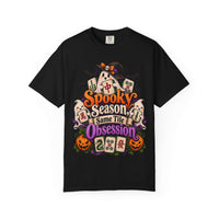 Flat lay of a black Halloween mahjong T-shirt with ghosts, pumpkins, mahjong tiles and “Spooky Season, Same Tile Obsession” lettering.
