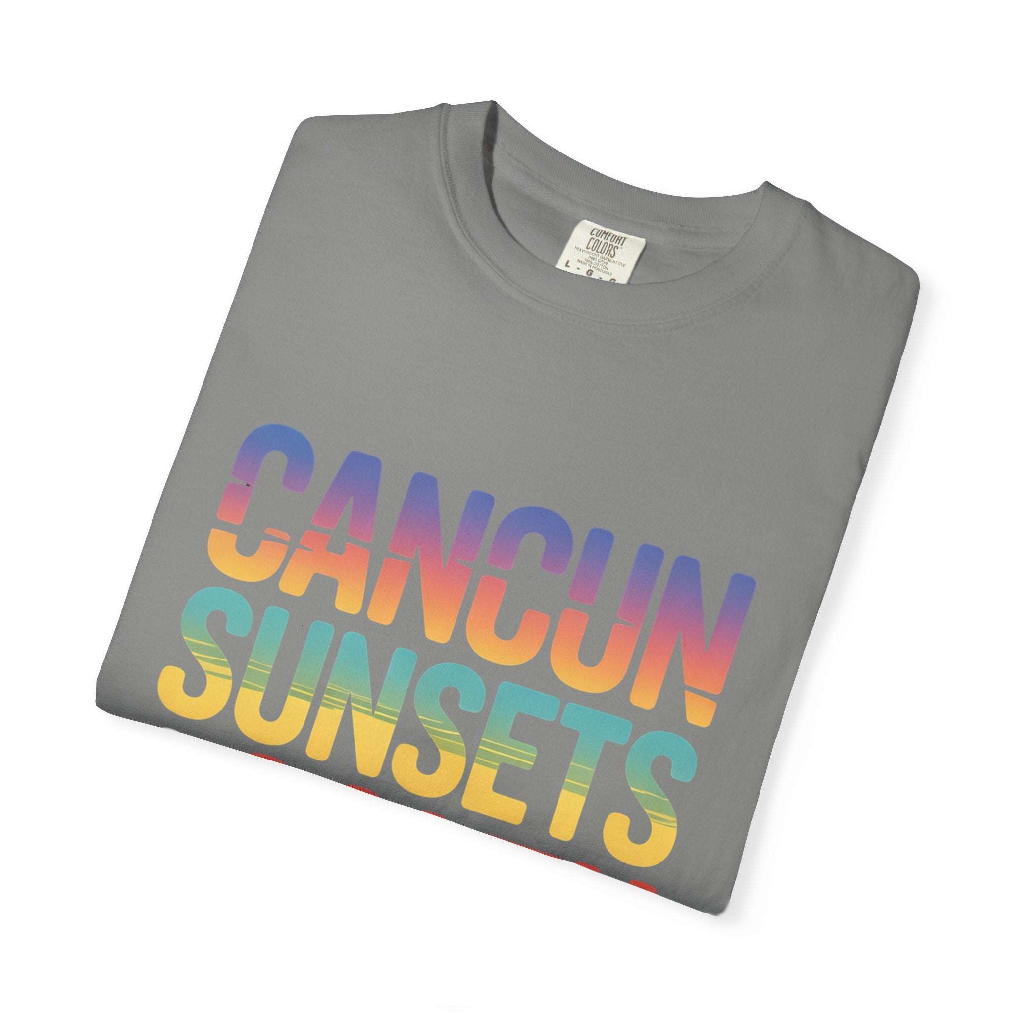 Folded gray t-shirt with 'Cancun Sunsets' in colorful letters on a white background