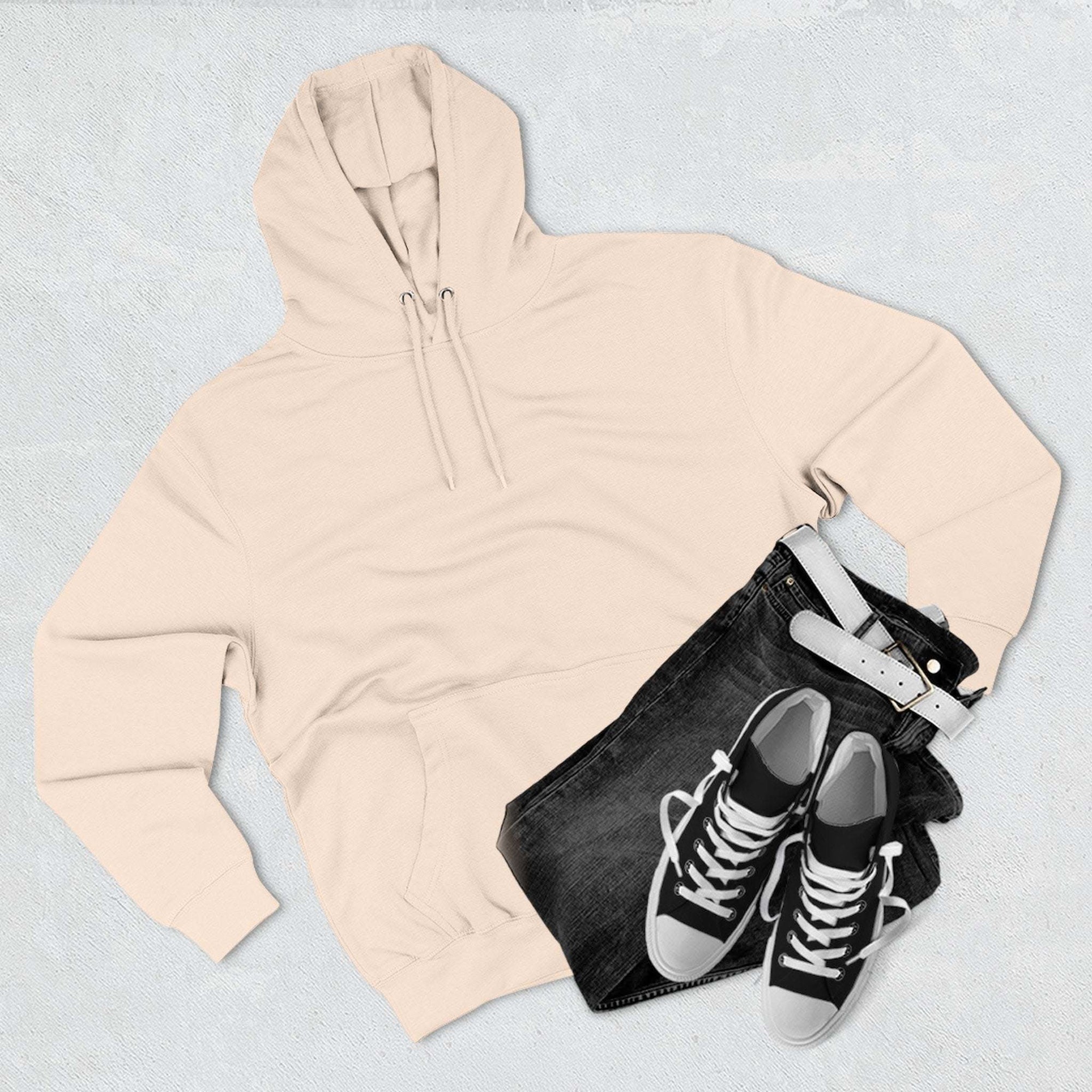 Pink fleece hoodie with adjustable hood, kangaroo pocket, paired with black jeans and sneakers on light background