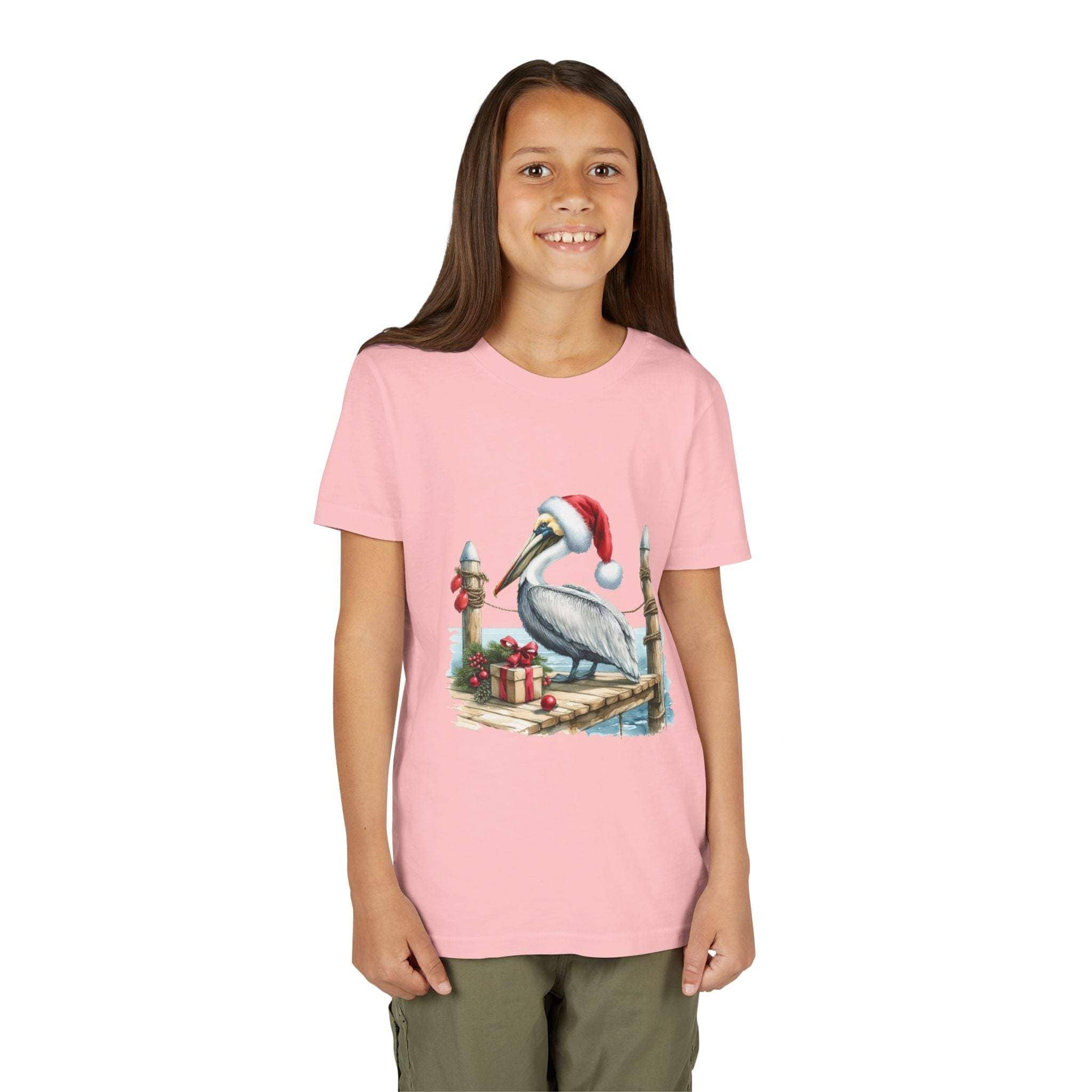 Girl wearing a pink t-shirt with a Christmas pelican design on a white background