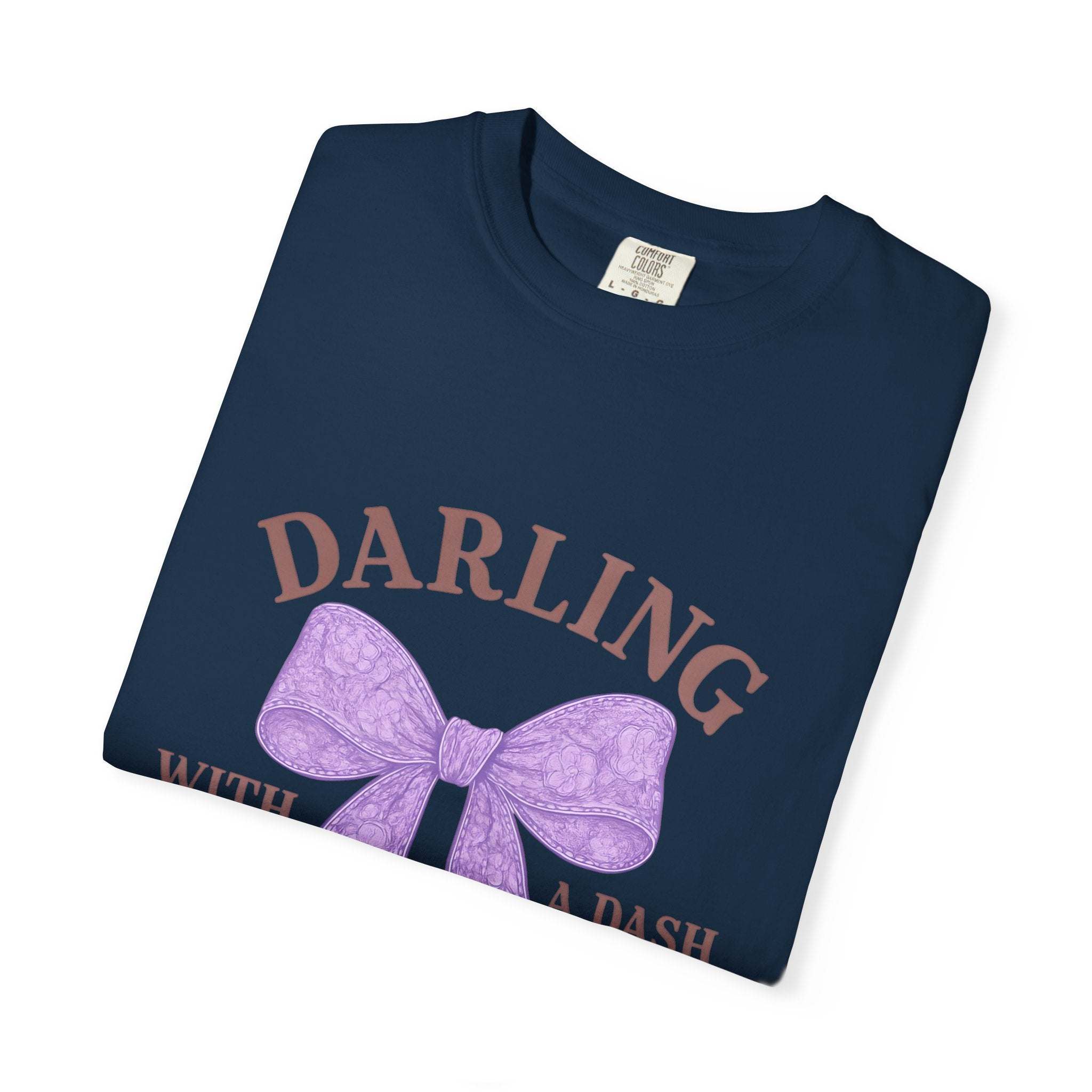 Folded navy blue t-shirt with a purple bow and text on a white background