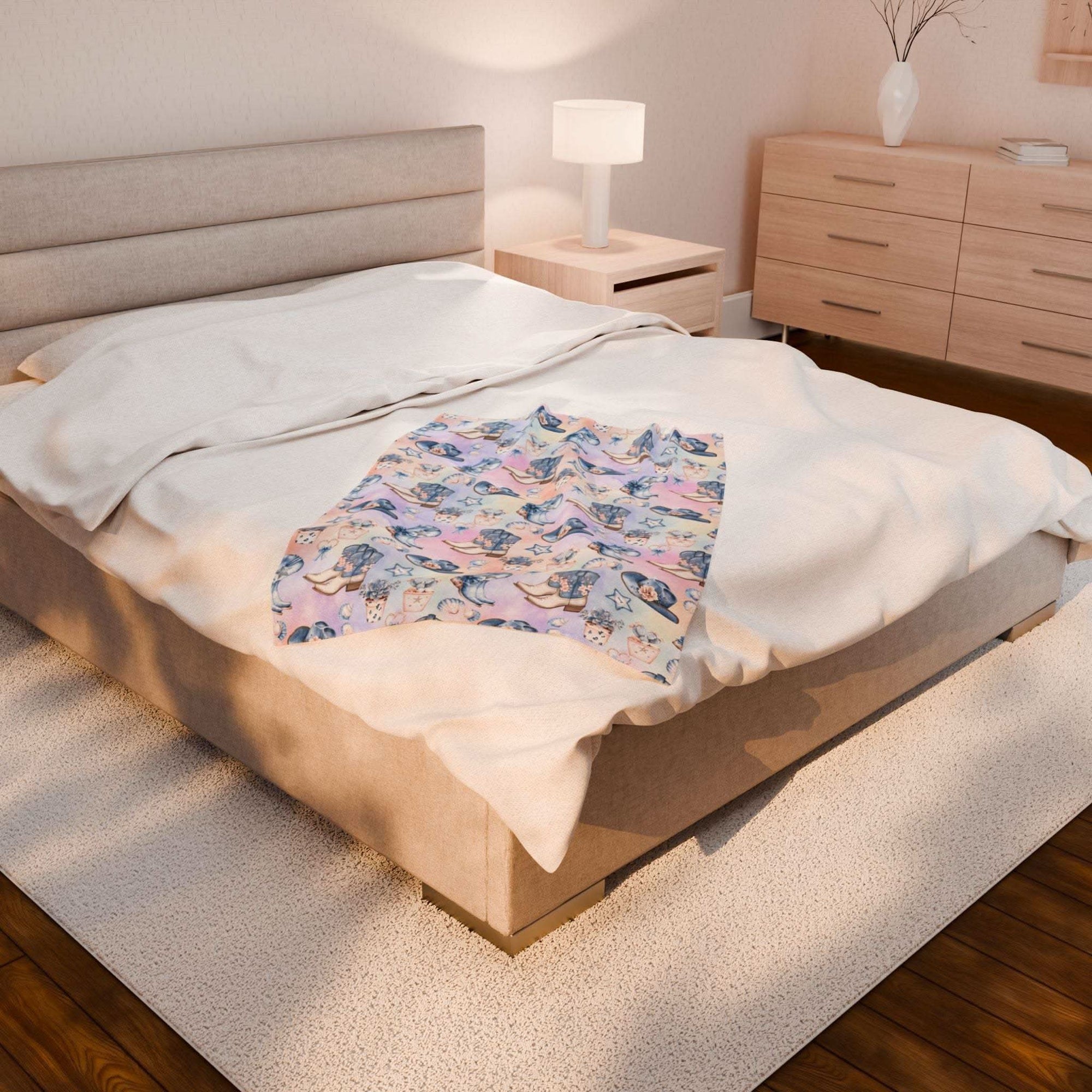 Coastal Cowgirl design plush blanket on bed in cozy modern bedroom setting