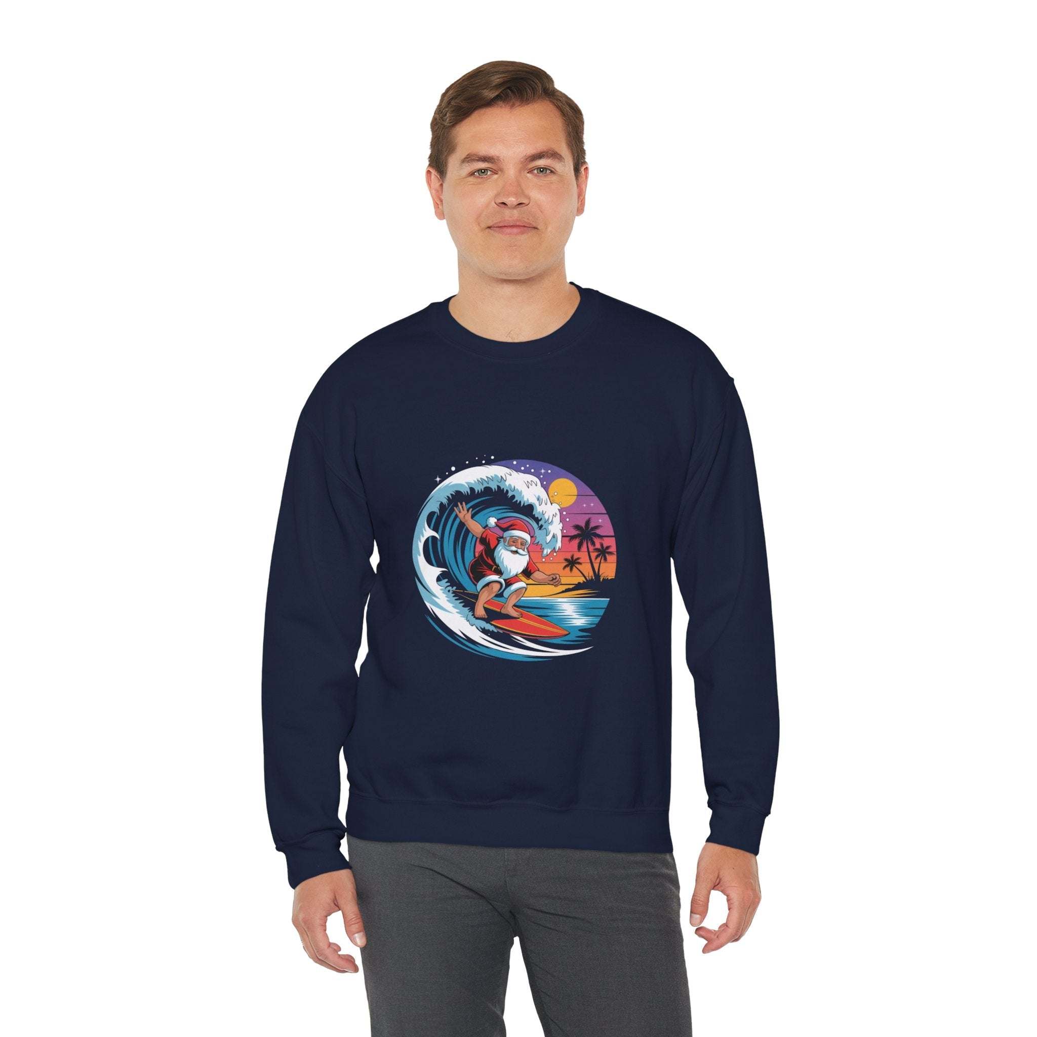 man wearing navy Surfing Santa Sweatshirt with colorful Santa surfing graphic on front