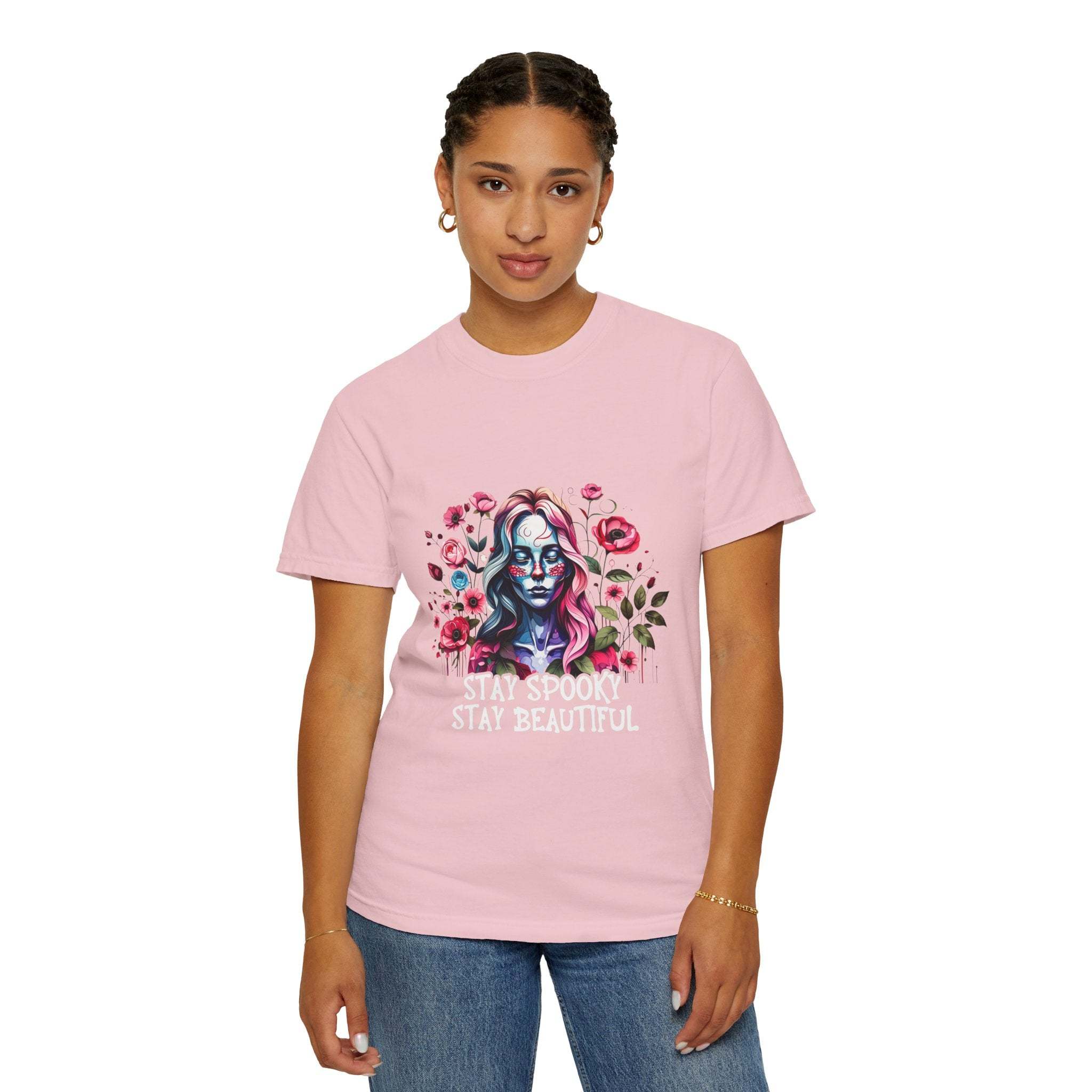 Woman wearing pink floral skeleton t-shirt with "Stay Spooky Stay Beautiful" text and relaxed fit