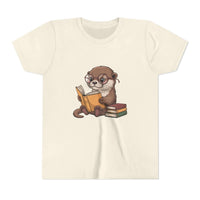 Beige t-shirt with an otter reading a book graphic on a white background