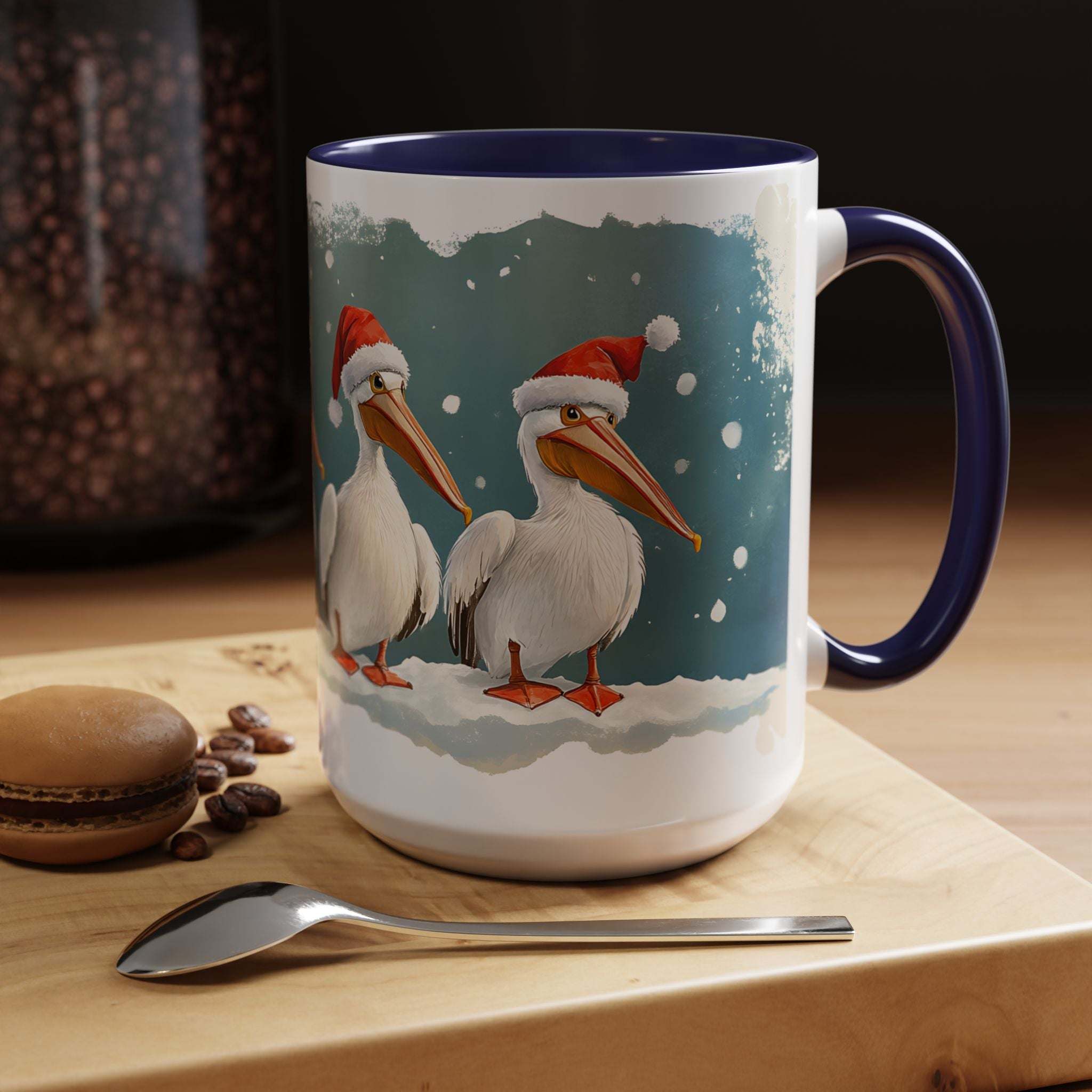 Mug with Christmas-themed design of pelicans wearing Santa hats on a wooden surface with coffee beans and a spoon.