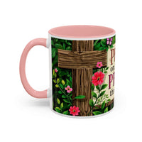 Mug with pink interior and handle, featuring a wooden cross and floral design on a white background